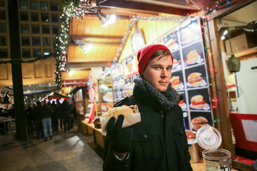 Young adult man at an outdoor public Christmas market