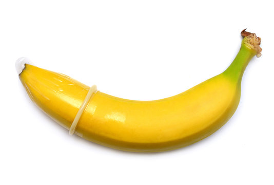 Banana with condom isolated on white background