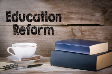 Education Reform. Stack of books on wooden desk.