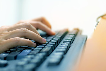 Female worker typing on the keyboard