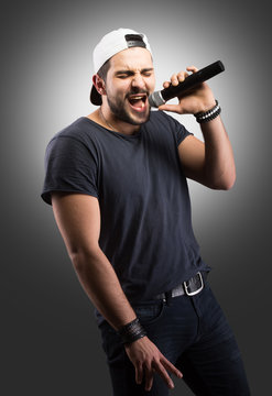 Young man singing into a microphone