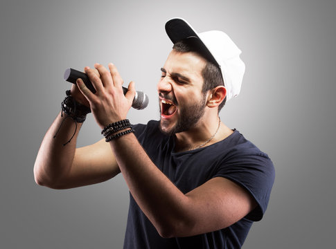 Young Man Singing Into A Microphone