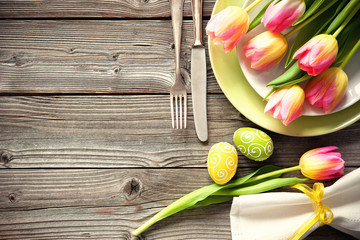 Easter table setting with spring tulips and cutlery