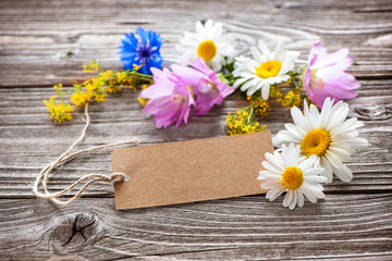Fototapeta na wymiar Wild Flowers with a vintage tag