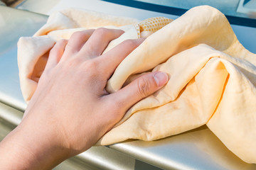 Close up of Hand Washing Car with Yellow Chamois (microfiber towel) - Cleaning Concept