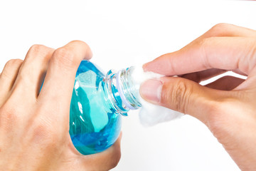 man holding ethyl alcohol bottle and cotton ball backgroud