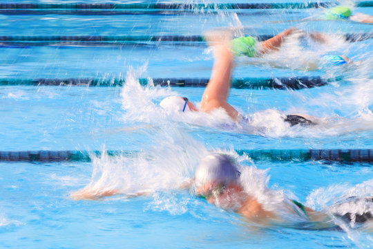 Motion blurred freestyle swimmers in a race