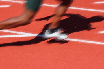 Motion blurred runners shadow, track and field race