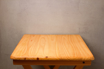 Background with empty wooden table over grunge wall