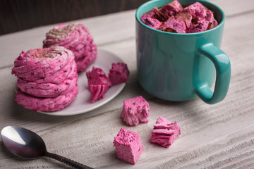 Latte with pink marshmallow. Winter drink theme. Blue cup of hot cocoa with pink marshmallows. Hot...