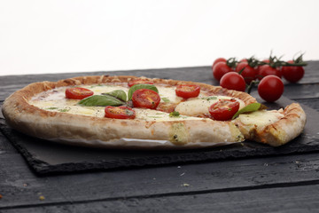 Hot true PEPPERONI ITALIAN PIZZA with salami and cheese. TOP VIEW Tasty traditional pepperoni pizza on board on wooden table with decoration