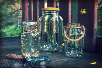 Fireflies in jars in a tree house, with magnifying glass.