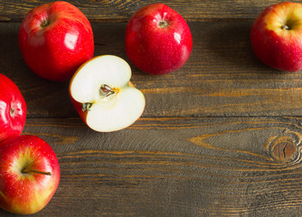 Fresh red apples on wooden table. On wooden background. Free space for text . Top view