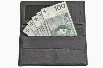 Polish zloty bills in black leather wallet isolated on white