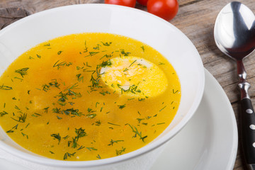 Yellow soup with egg