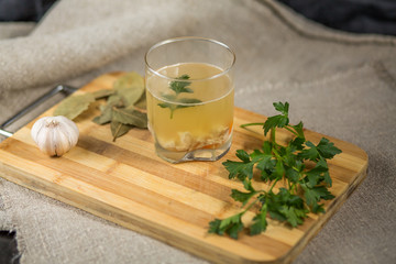 Jellied dish with chicken, carrots and parsley on a wooden board
