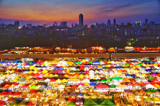 During the twilight of the market with a colorful umbrella. The rear view of the city, in Bangkok, Thailand.