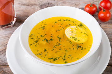 Yellow soup with egg