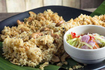 Crispy catfish salad on wooden table.