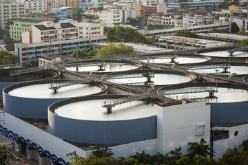Modern urban wastewater treatment plant.Water purification is the process of removing undesirable chemicals, suspended solids and gases from contaminated water. Water cleaning facility outdoors.
