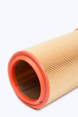 Round car engine air filter isolated over white background