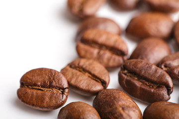 roasted coffee beans isolated in white background. Roasted coffee beans background close up. Coffee beans pile from top on white background with copy space for text. Good morning.