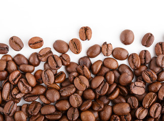 roasted coffee beans isolated in white background. Roasted coffee beans background close up. Coffee beans pile from top on white background with copy space for text. Good morning.