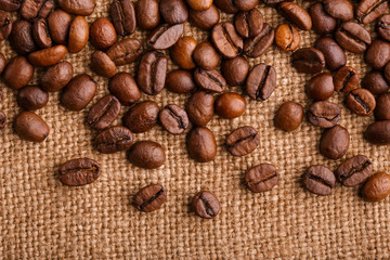 coffee beans on burlap background. roasted coffee beans isolated in white background. Roasted coffee beans background close up. Coffee beans pile from top on white background with copy space for text