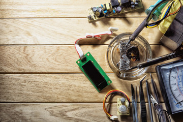 Repair of electronic equipment using a soldering iron.
