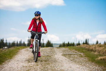 Fototapeta na wymiar Middle-aged woman riding bicycle 