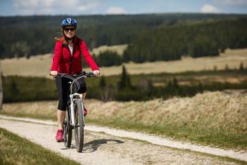 Fototapeta premium Middle-aged woman riding bicycle 