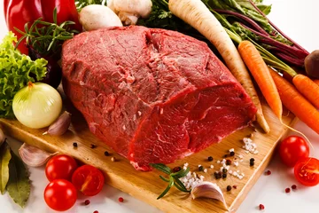 Tuinposter Vlees Raw meat on cutting board  and vegetables