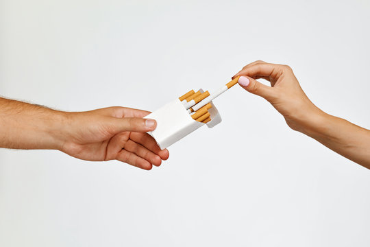 Smoking. Closeup Hand Holding Cigarettes Pack, Taking Cigarette