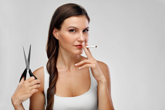 Closeup Of Beautiful Woman With Scissors Smoking Cigarette