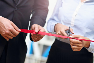 Businesspeople cutting the ribbon