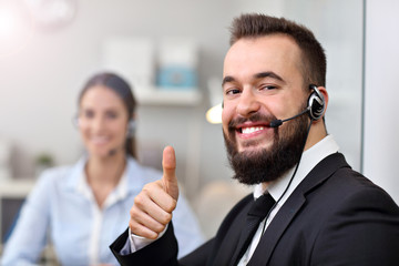 Happy man in call center
