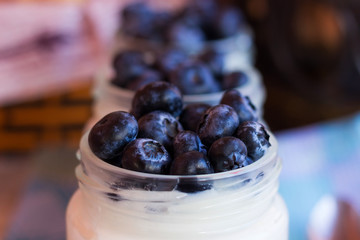 Yogurt with berries in a glass jar