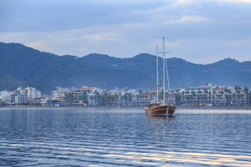 Vintage ship with marmaris city background.
