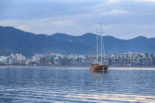 Vintage ship with marmaris city background.