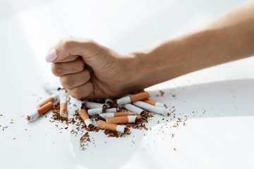 Closeup Of Woman Hand Breaking Cigarettes. Quit Bad Habit