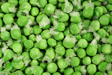 Close-up of frozen green peas with ice crystals. Food background.