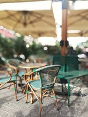 Isolated vintage green chair on a restaurant terrace with nobody on a sunny day