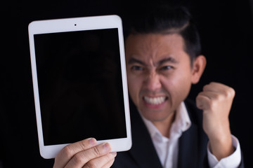 A business man showing black screen of touch pad with copy space and a big success face.