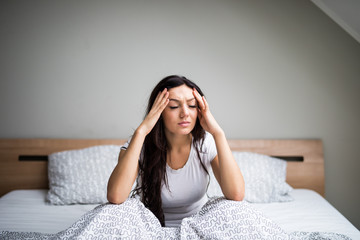 Young woman feel  sick and unwell on bed