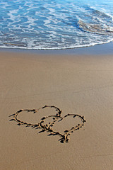 Hearts entwined on the beach 