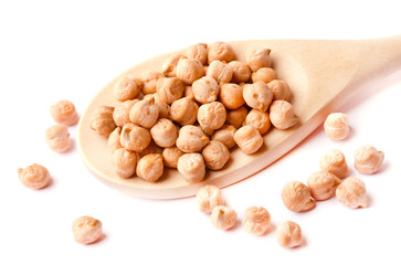 Dry chickpeas on a wooden spoon, isolated on white background