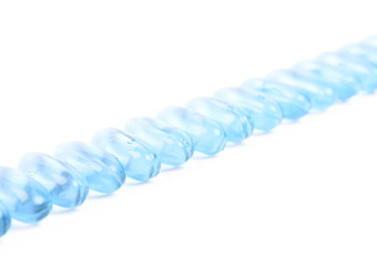Line of multiple softgel pills isolated
