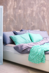 Comfortable bed with pillows in bedroom