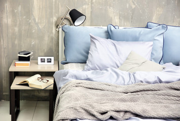 Bedroom interior with bed and nightstand on grungy wall background