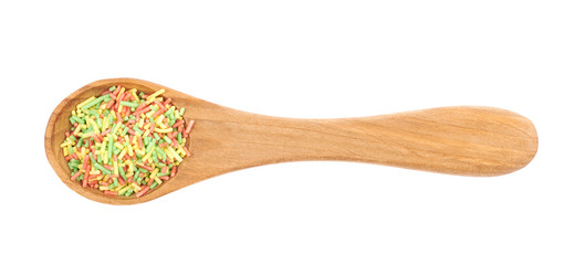 Spoon full of candy sprinkles isolated